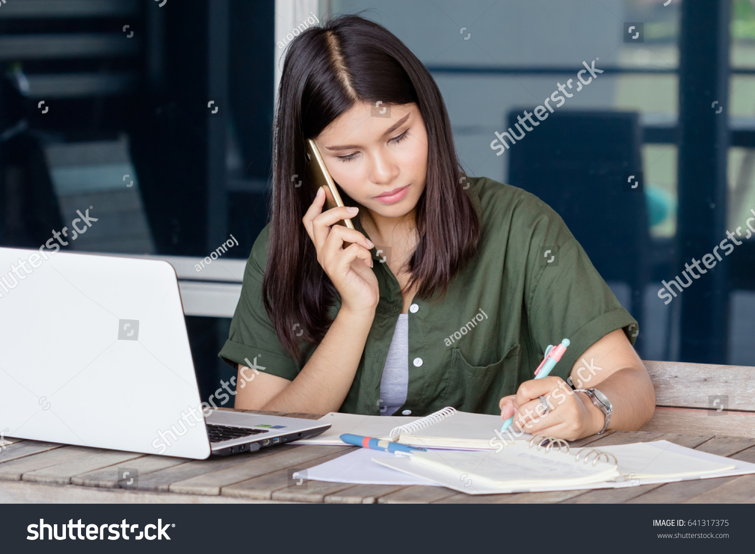 Stock Photo Beautiful Asian Woman Writing And Talk Smartphone On The Wooden Table With Notebook Pen Papersheet 641317375